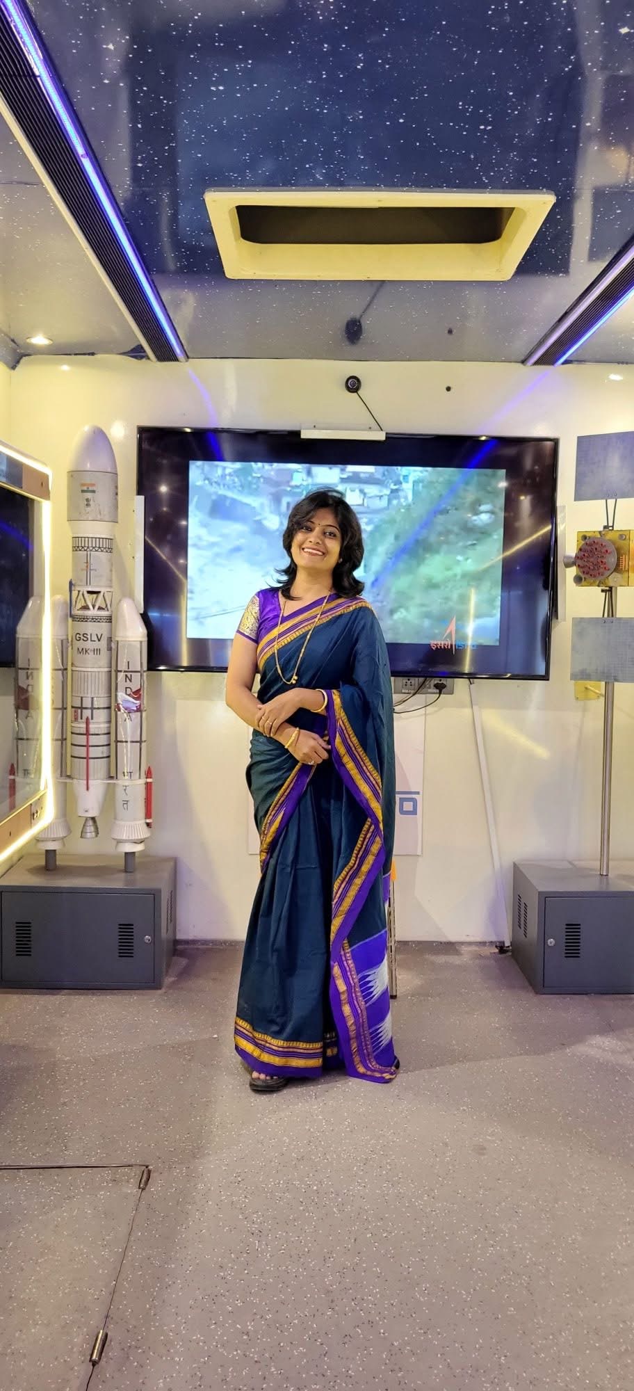 Priyanka at a space-science exhibition beside a GSLV model